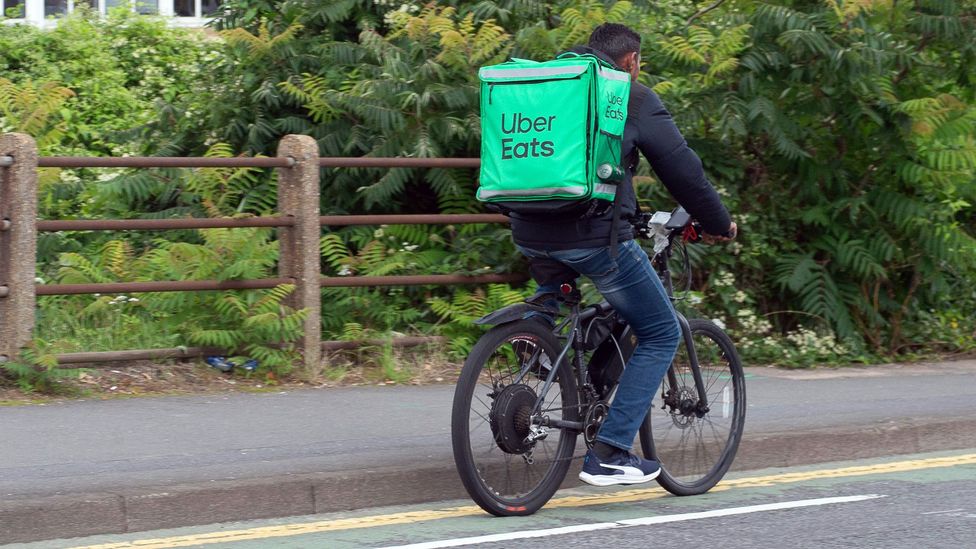 Uber Eats worker delivering in the UK on bike