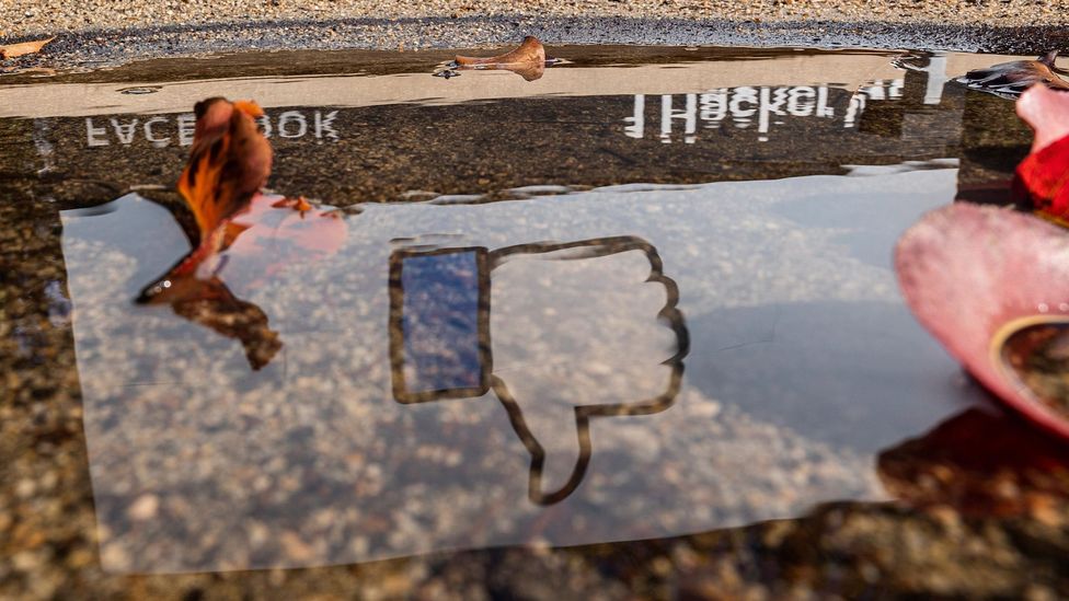 The Facebook logo reflected in a puddle at the company's headquarters in Menlo Park