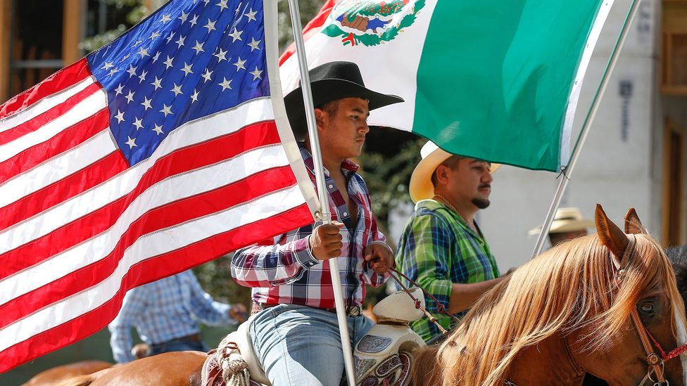 Horse riders carry American and Mexican flags during the Annual Houston Fiestas Patrias Parade in Houston (Credit: Getty Images)