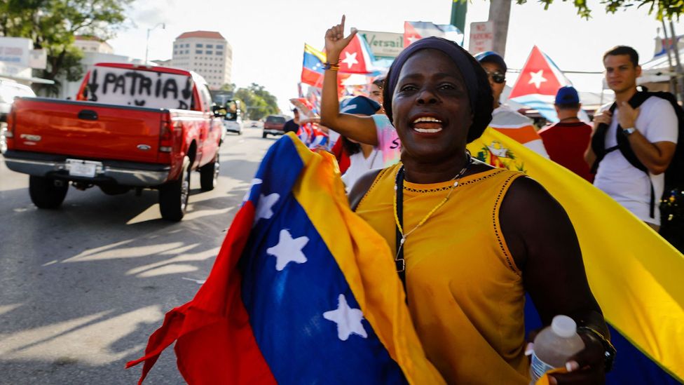 A woman holds a Venezuelan flag in Miami (Credit: Getty Images)