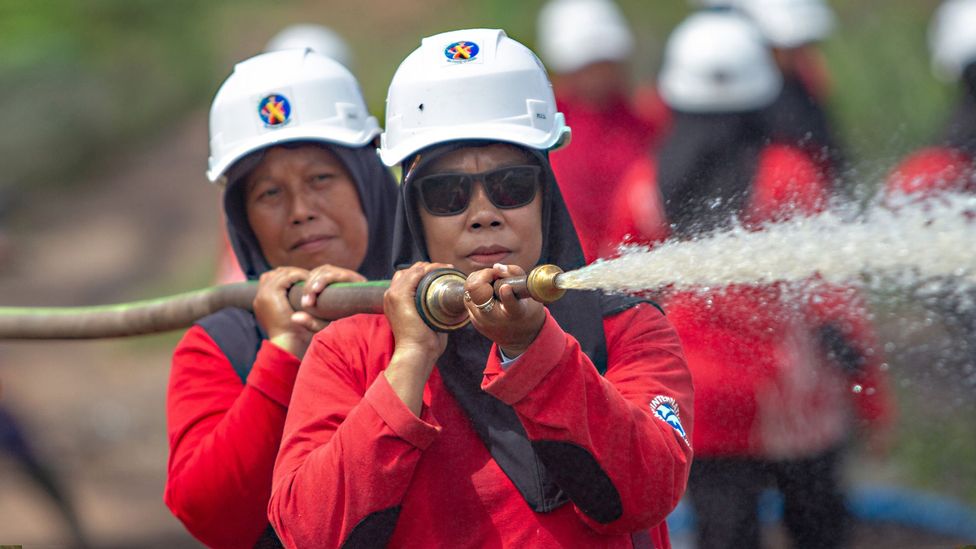 Two members of the Power of Mama, Borneo's women volunteer firefighters (Credit: Victor Fidelis Sentosa)