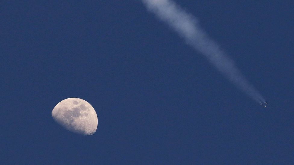 Moon and rocket trail in sky (Credit: Getty Images)