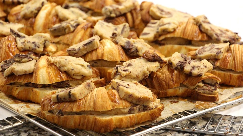 Croissants are filled and topped with chocolate chip cookie dough before they are baked (Credit: Emily Monaco)