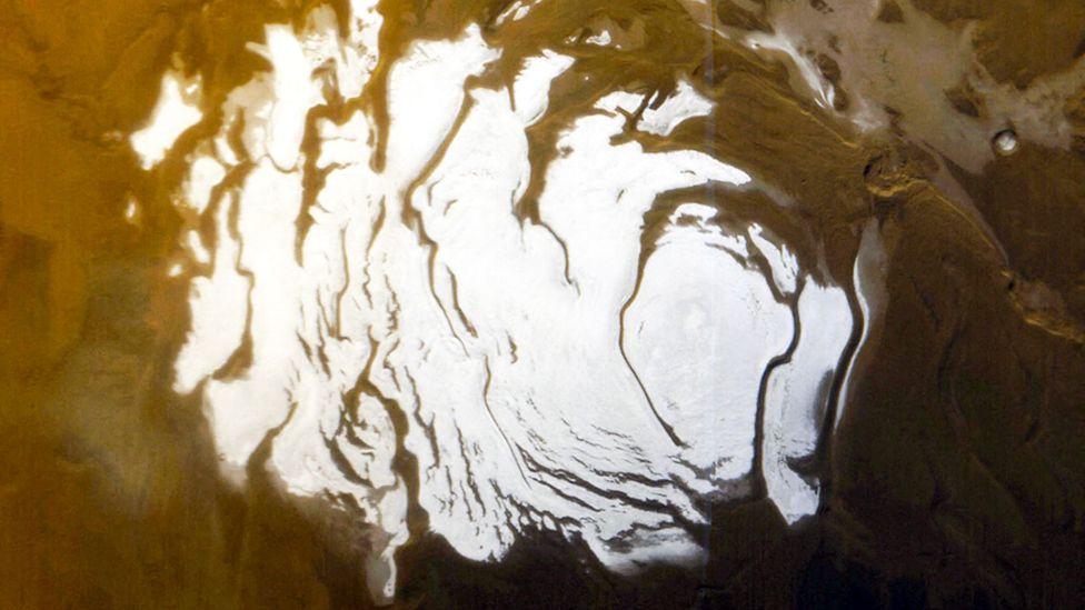 Recent research using radar from orbiting satellites has suggested there may be liquid water beneath the Martian southern ice cap (Credit: Getty Images)