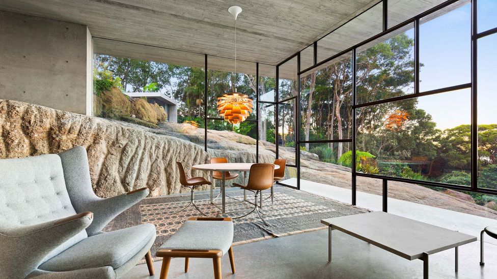 The Australian landscape rolls through a neo-brutalist bunker in a suburb of Newcastle, with the house integrated into hillside contours (Credit: James Stockwell Architect)