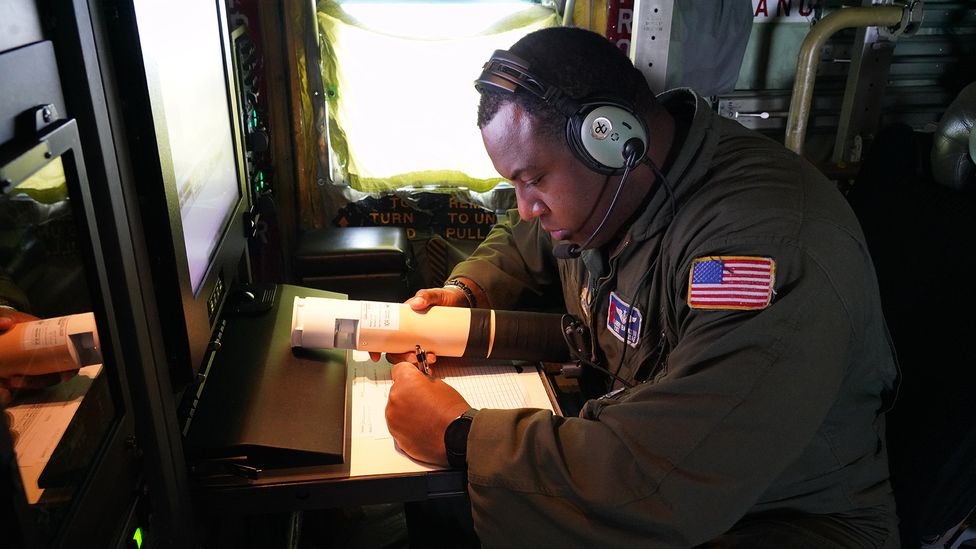 Tech. Sgt. Larry Banks checks a dropsonde during an atmospheric rivers mission in 2023 (Credit: US Air Force)