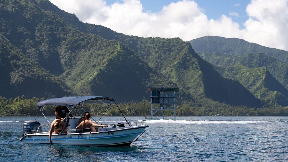 Locals take in the view of the new Olympic judging tower from their boat at Teahupo'o, Tahiti (Credit: Atea Lee Chip Sao)
