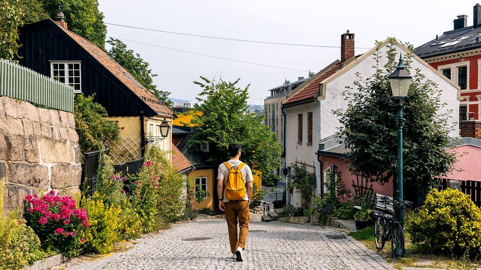 Rear view of a man with backpack walking in Oslo old town (Credit: Getty Images)