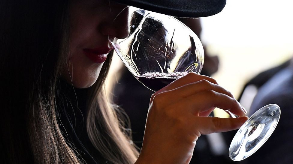 A woman drinking a glass of red wine (Credit: Getty Images)