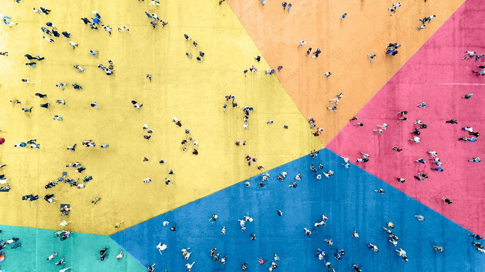 Ground painted in different colours with people walking across (Credit: Getty Images)