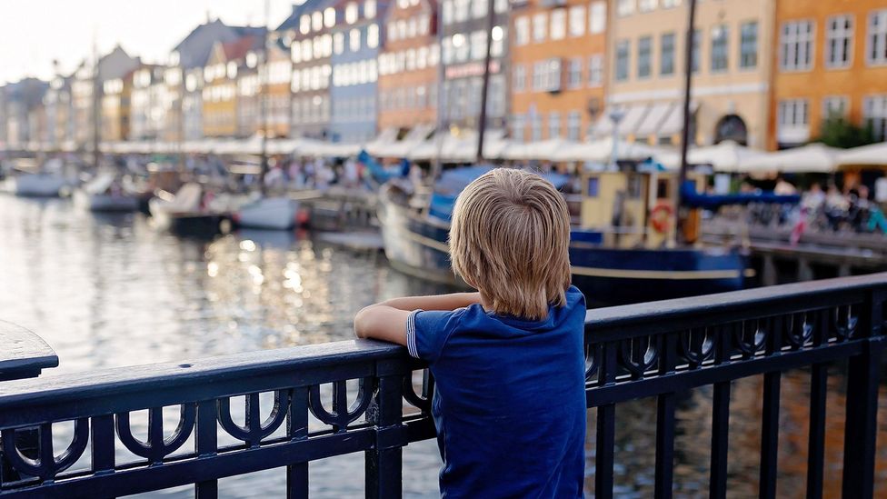 Child looking out onto river from bridge in Nyhavn, Copenhagen (Credit: Alamy)