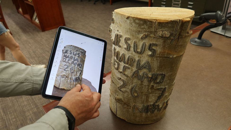 Iñaki Arrieta Baro holds a photo of a Basque arborglyph (Credit: Haley Harrison)