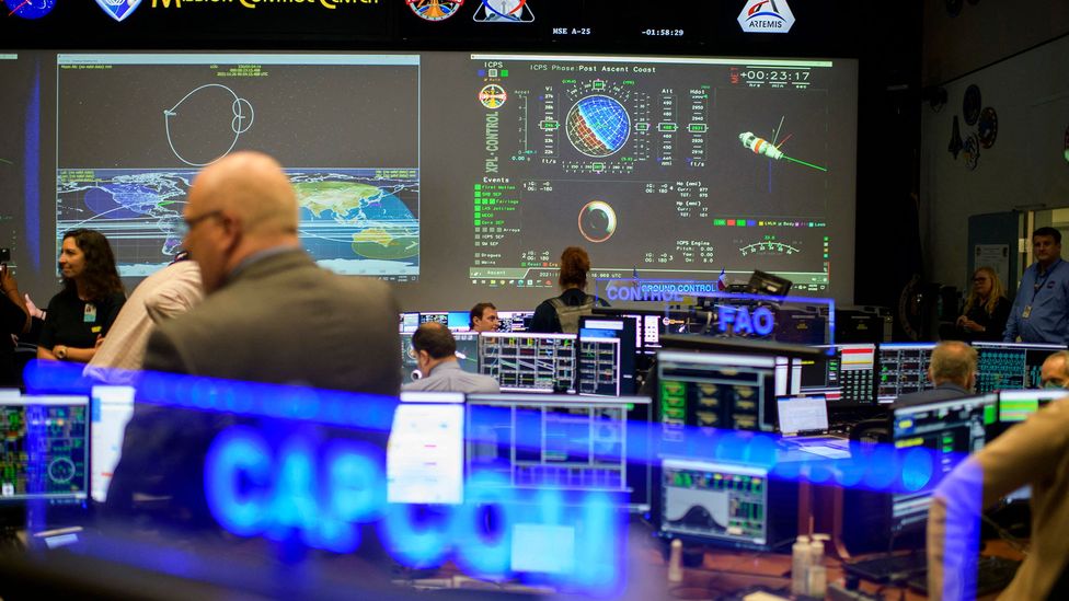 Artemis Mission Control, a modern room with many desks and screens facing one large central screen covered in information (Credit: Getty Images)