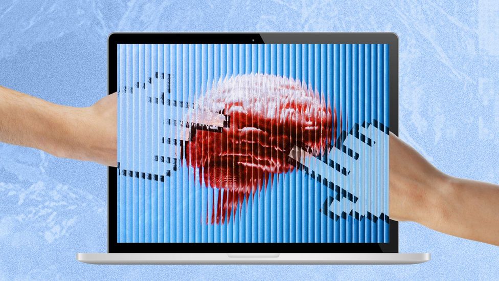 A laptop computer screen displaying an image of a brain with ridges, with two hands transforming into cursors pointing at it (Credit: Serenity Strull/ BBC/ Getty Images)