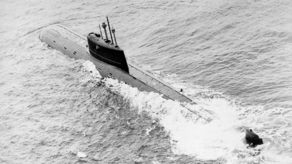 A black-and-white photo of a Soviet nuclear-powered submarine breaking through the ocean surface (Credit: Alamy)