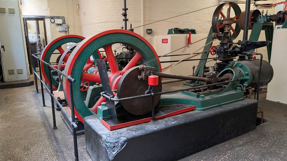 Machinery painted red and green in a brick-walled room (Credit: Chris Baraniuk)