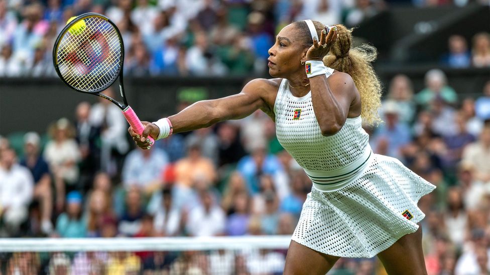 Serena Williams hits a tennis ball during a Wimbledon match (Credit: Getty Images)