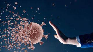 Person stopping flu virus (Credit: Getty Images)