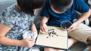 Children play Go, an ancient game still enjoyed today (Credit: Getty Images)