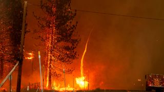 A whirl of fire shoots up into the draft of a PyroCb in California, July 2020, which saw some of the most devastating fires in US history (Credit: Getty Images)